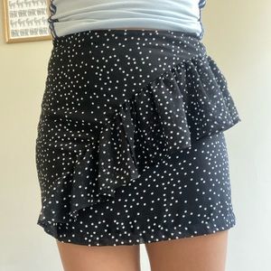 Black mini skirt with asymmetrical ruffle